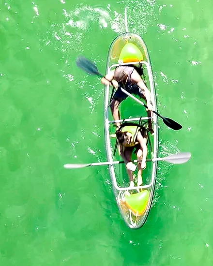 Two people in a clear kayak seen from above
