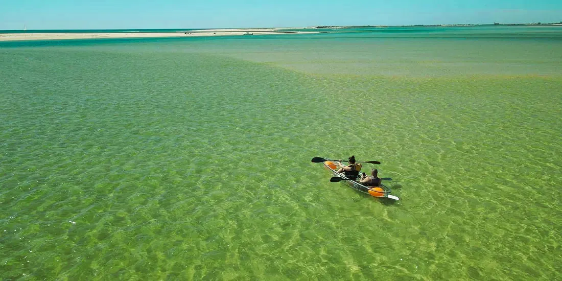 Clear kayak in shallow lagoon water